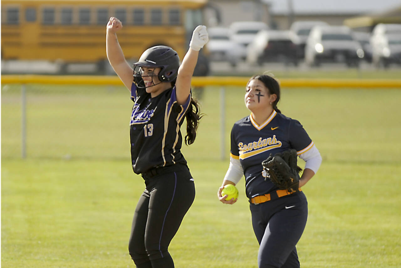 Sequim's Taylee Rome (13) celebrates a double as Forks' Lizzy Soto brings the ball into the infield Tuesday in Sequim. (Michael Dashiell/Olympic Peninsula Sports Group)