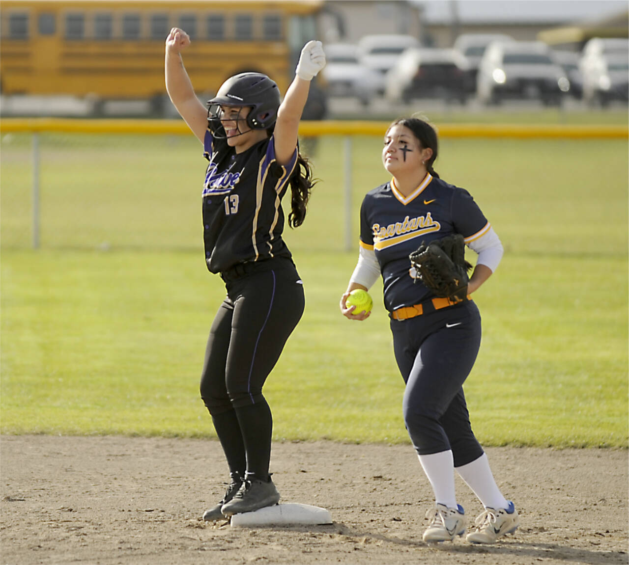 Sequims Taylee Rome (13) celebrates a double as Forks Lizzy Soto brings the ball into the infield Tuesday in Sequim. (Michael Dashiell/Olympic Peninsula Sports Group)