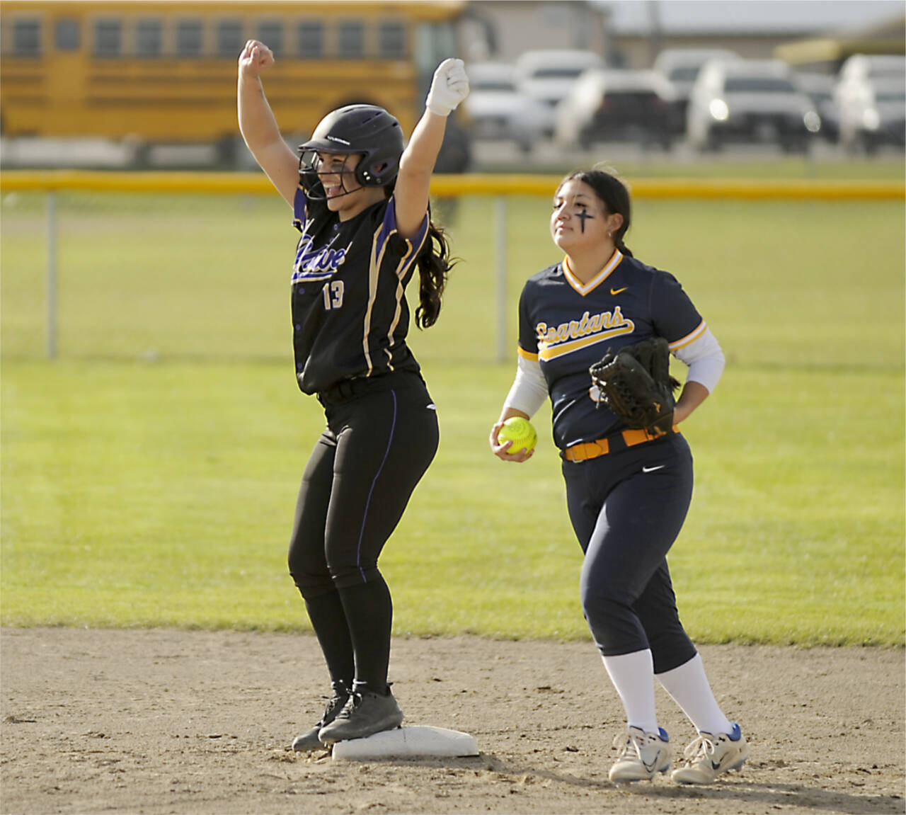 Sequim’s Taylee Rome (13) celebrates a double as Forks’ Lizzy Soto brings the ball into the infield Tuesday in Sequim. (Michael Dashiell/Olympic Peninsula Sports Group)