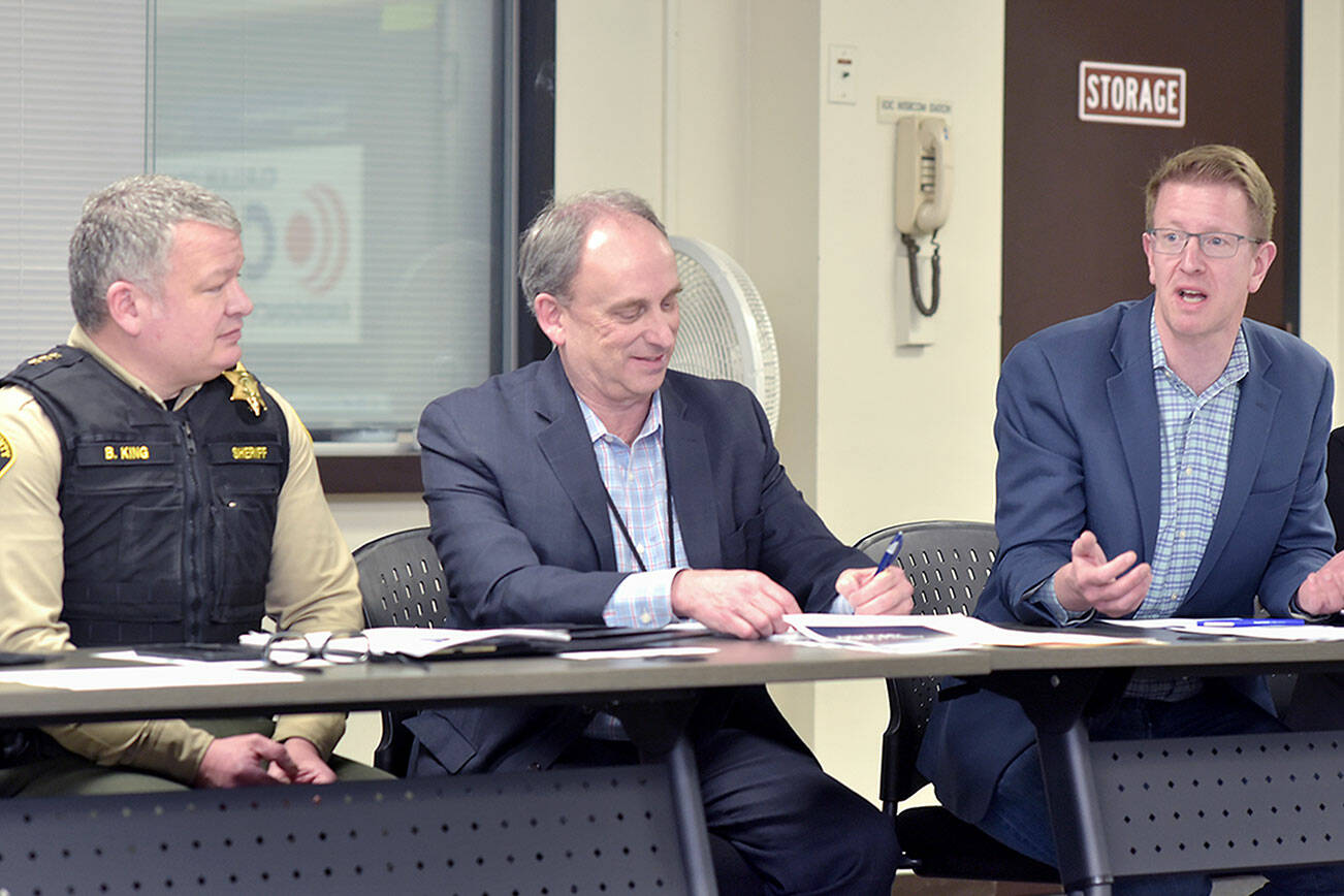 U.S. Rep. Derek Kilmer, right, discusses emergency services on Thursday during a roundtable session with emergency managers from across the region, including Clallam County Sheriff Brian King, left, and Clallam County Administrator Todd Mielke in Port Angeles. (Keith Thorpe/Peninsula Daily News)