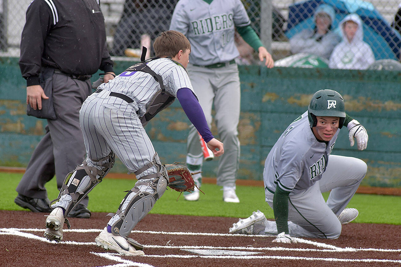 KEITH THORPE/PENINSULA DAILY NEWS
Port Angeles' Kaleb Mullen, right, looks back at North Kitsap catcher Greyson Prichard after making it home in the second inning as Mullen's teammate, Rylan Politia waits to bat on Tuesday at Volunteer Field.