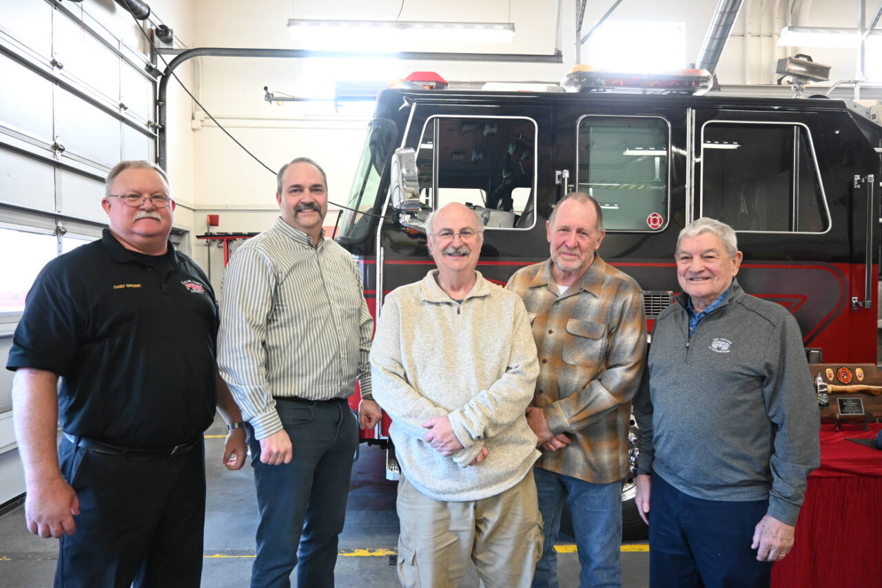 Current and former fire chiefs with Clallam County Fire District 3 gather to send off outgoing chiefs Ben Andrews and Dan Orr. Pictured, from left, are: current District 3 chief Justin Grider; Andrews; former chief Steve Vogel; Orr, and former chief Tom Lowe. (Michael Dashiell/Olympic Peninsula News Group)