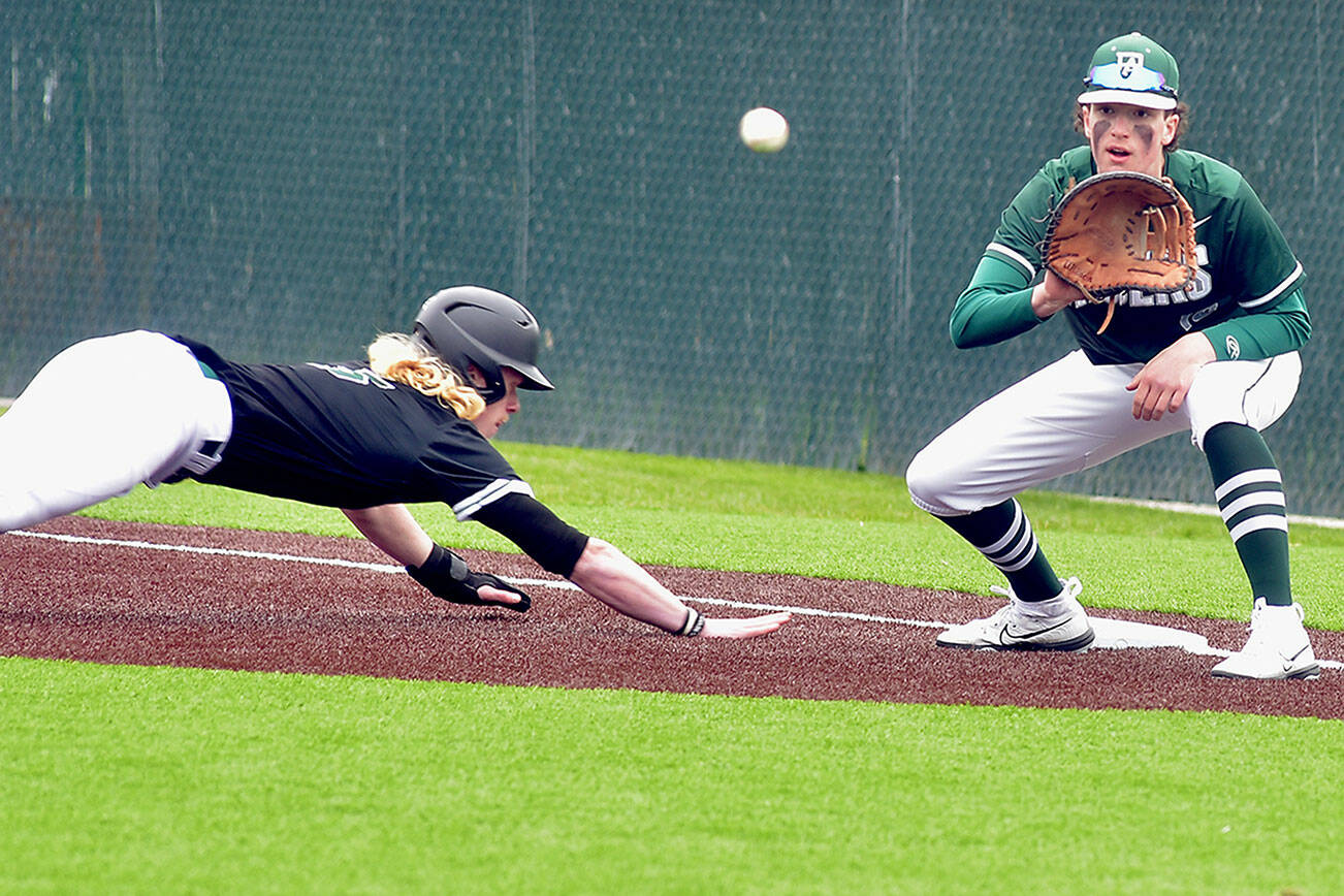KEITH THORPE/PENINSULA DAILY NEWS
Port Angeles first baseman Rylan Politika tries to catch Klahowya's Carson Moore off the bag during Friday's game at Volunteer Field.