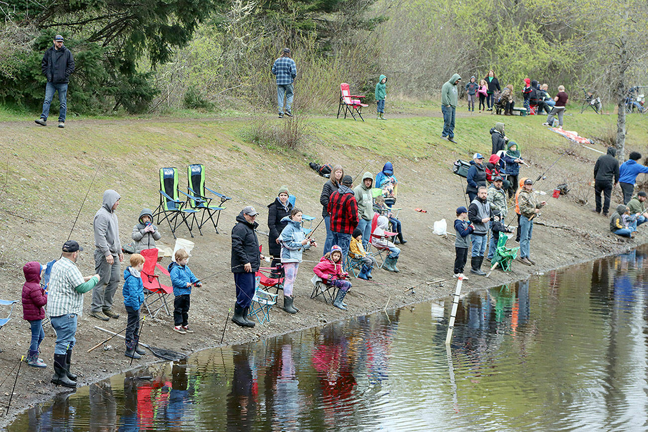 (Above) Dozens of kids from all around the Olympic Peninsula came out to the Lincoln Park ponds Saturday morning at the annual Kids' Fishing Derby sponsored by the Olympic Peninsula Fly Fishers. The Kiwanis, Les Schwab, Re/Max Realty and Swain’s General Store are all supported the event with the Kiwanis Club serving hot dogs. (Dave Logan/for Peninsula Daily News)