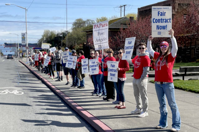 Members of the Port Angeles Paraeducators Association gather on Lincoln Street on Sunday morning, a day before a planned strike if an agreement cannot be reached with the Port Angeles School District over a new contract. (Paula Hunt/Peninsula Daily News)