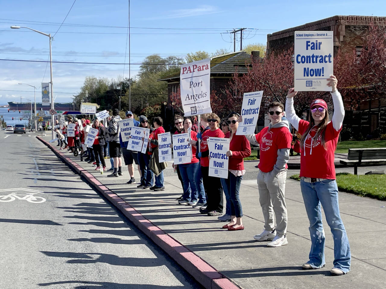 Members of the Port Angeles Paraeducators Association gather on Lincoln Street on Sunday morning, a day before a planned strike if an agreement cannot be reached with the Port Angeles School District over a new contract. (Paula Hunt/Peninsula Daily News)