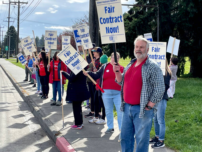 Port Angeles High School English teacher Mark Valentine is among picketers on Lauridsen Boulevard on Monday. Port Angeles School District schools were closed as 130 members of the Port Angeles Paraeducators Association went on strike. They have been working without a contract since August. (Paula Hunt/Peninsula Daily News)