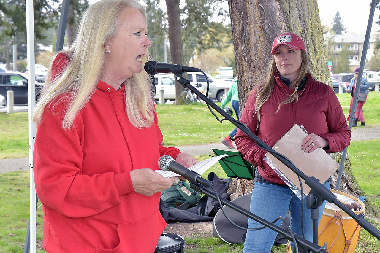 Retired teacher Nancy McCaleb speaks in support of striking paraeducators in the Port Angeles School District as Port Angeles Paraeducators Association President Rebecca Winters listens during a rally on Thursday at Shane Park. (KEITH THORPE/PENINSULA DAILY NEWS)