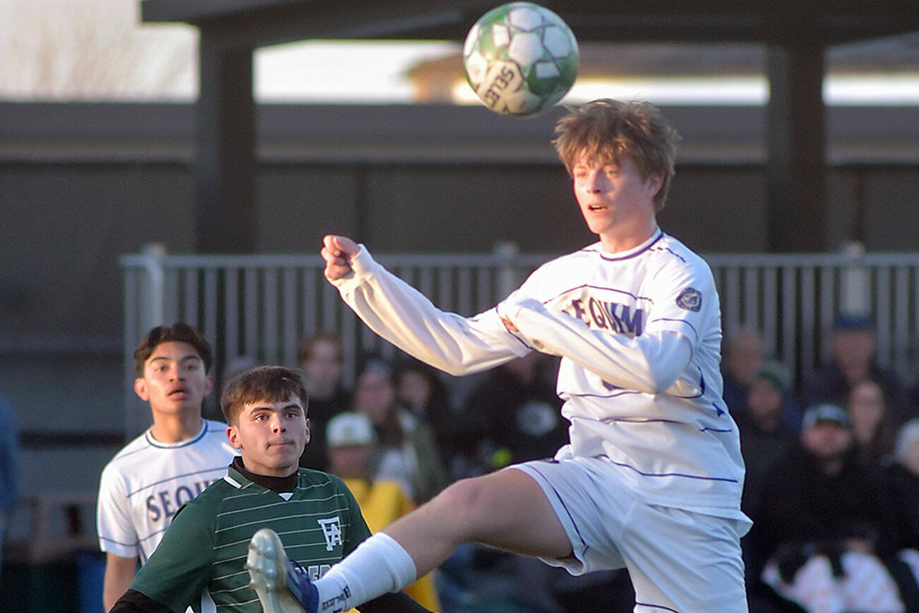 KEITH THORPE/PENINSULA DAILY NEWS
Sequim's Finn Braaten, front, takes a header as Port Angeles' A.J. Martinez keeps watch on Thursday at Peninsula College.