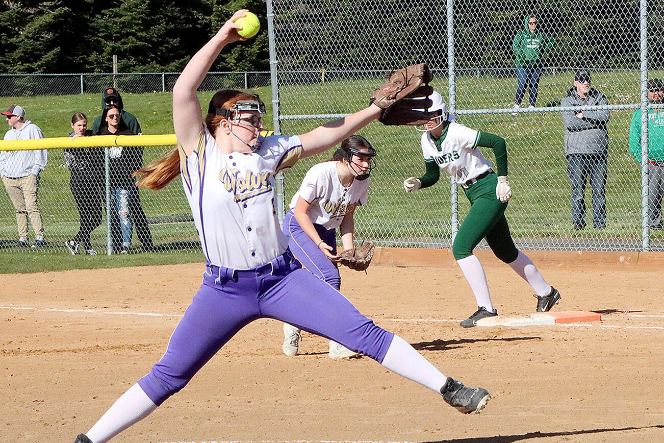 Sequim’s pitcher Nevaeh Owens delivers to the plate while the PA runner at first Lexie Smith is ready to take off. Sequim first baseman is Rylie Doig also ready for a play. dlogan
