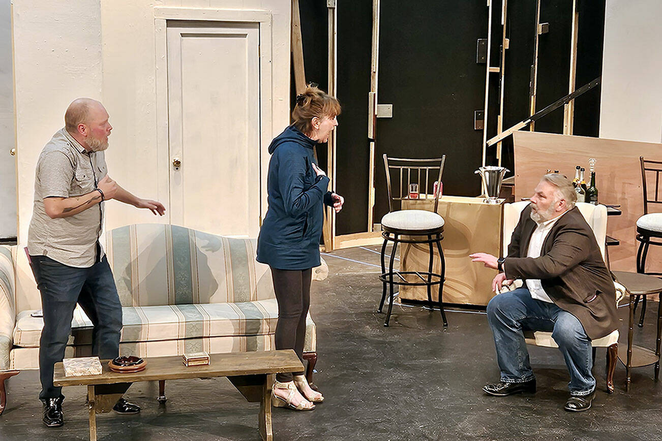 From left to right, Zach Wiedenhoeft, Rebecca Gilbert and Mark Valentine, all of Port Angeles, participate in a recent rehearsal on the unfinished set of “Rumors.”