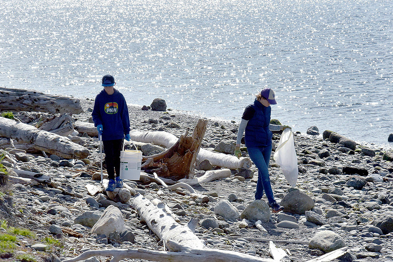 Isaac Wendel, 11, left, and his mother Jennie Wendel of Port Angeles, comb the beach on the inside of Ediz Hook in Port Angeles on Saturday as part of a cleanup effort hosted by Washington CoastSavers in honor of Earth Day. Hundreds of volunteers fanned out across numerous beaches on Washington’s Pacific Coast and along the Strait of Juan de Fuca to collect trash and other unwanted debris. (Keith Thorpe/Peninsula Daily News)
