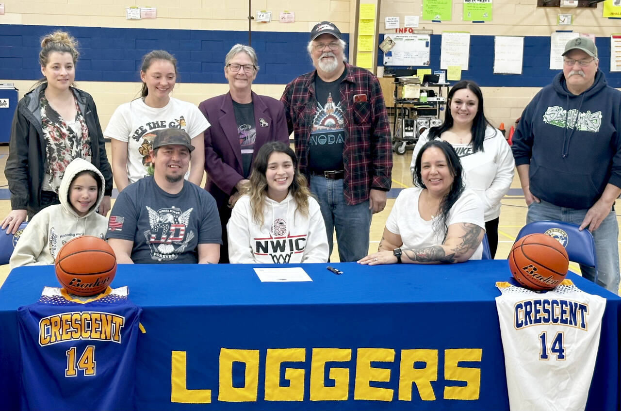 Crescent’s Ciara Cargo-Acosta, center, signs to play basketball for Northwest Indian College. She is flanked by parents Jeremy Acosta and Vashti White-Acosta. (Courtesy photo)