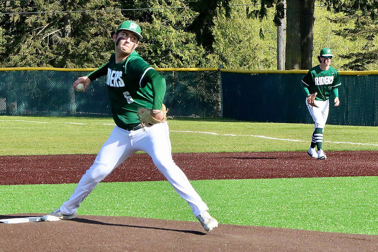 Colton Romero pitches to Bainbridge Monday afternoon at Volunteer Field. Playing first is Rylan Politika, who later came in to pitch. Romero and Politika allowed just five hits in a 5-4 Port Angeles win. (Dave Logan/for Peninsula Daily News)
