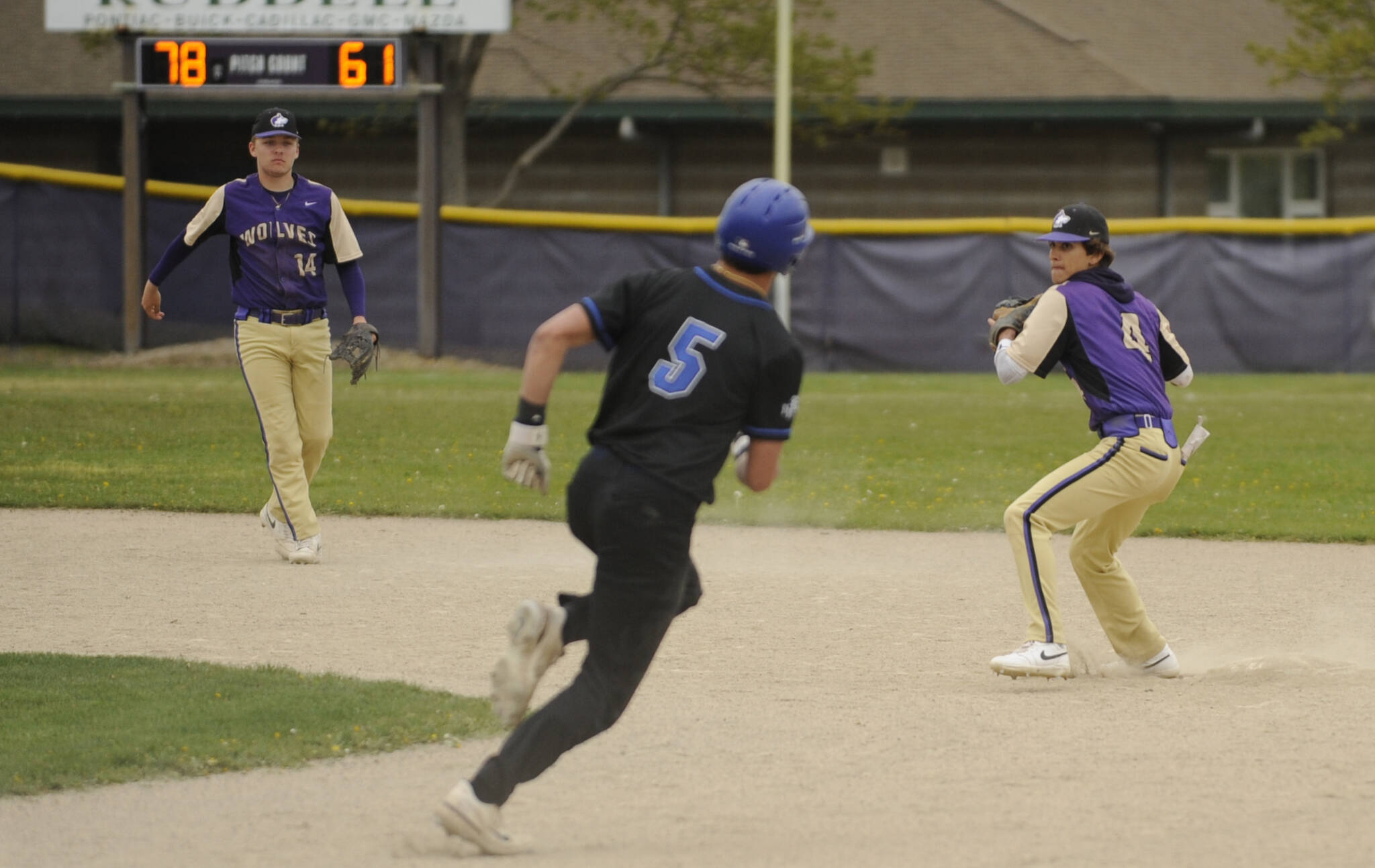 Michael Dashiell/Olympic Peninsula News Group (2)
With shortstop Devyn Dearinger (left) looking on, Sequim second baseman Bryan Laboy turns a double play in the top of the fifth inning as the Wolves beat North Mason 4-3 on Wednesday.