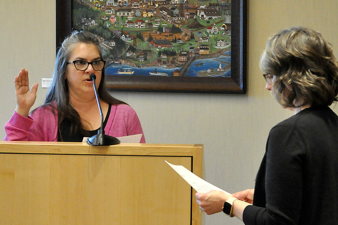 Acting city clerk Heather Robley, right, swears in new city council member Nicole Hartman on Monday after she was appointed to fill former mayor Tom Ferrell’s seat. Hartman will serve through certification of the 2025 general election. (Matthew Nash/Olympic Peninsula News Group)