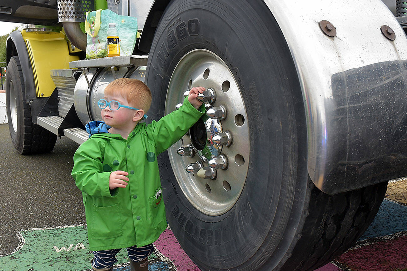 August Gala, 2, of Port Angeles spins an idle wheel of a truck belonging to Bruch & Bruch Construction during Saturday’s Touch a Truck event at Queen of Angeles School in Port Angeles. The event, hosted by the school’s parent-teacher organization, allowed youngsters and adults to visit and climb aboard a variety of construction, public safety and utility vehicles. (Keith Thorpe/Peninsula Daily News)