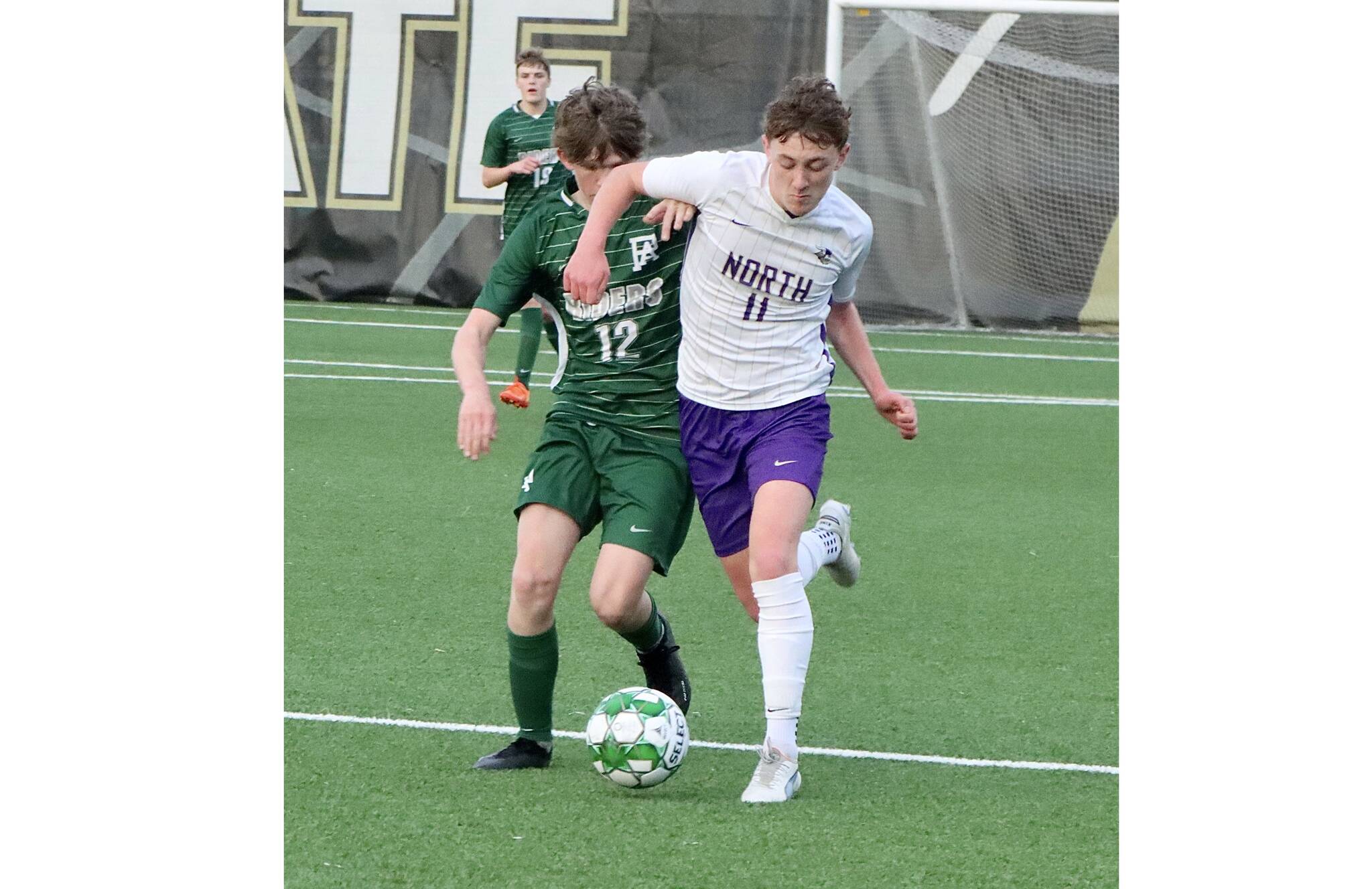 Port Angeles soccer player Cannon Wood (12) is elbowed out of the way by North Kitsap’s Ethan Peck (11) Friday night at Wally Sigmar Field at Peninsula College. (Dave Logan/for Peninsula Daily News).