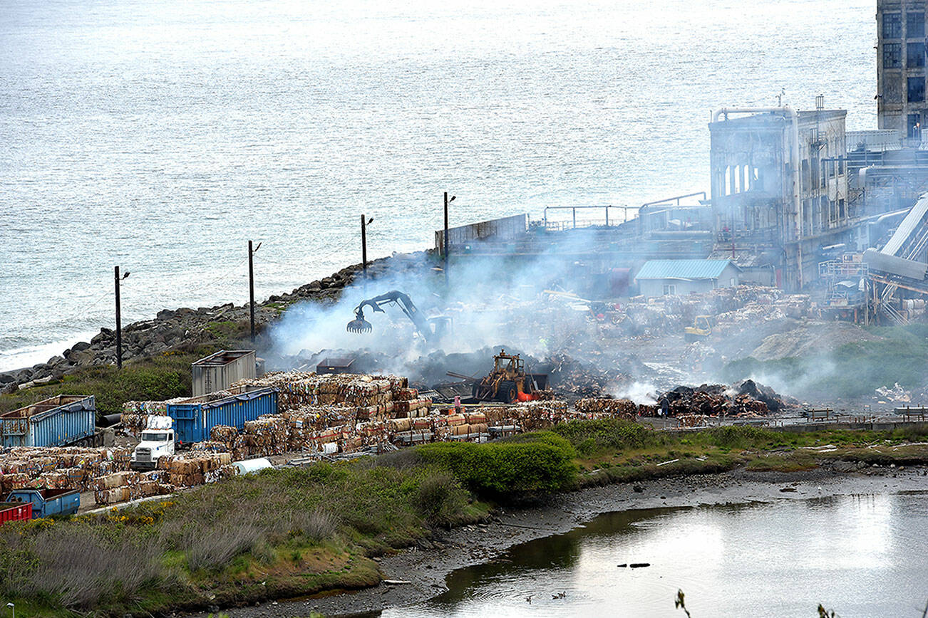 Smoke rises on Tuesday morning from the site of a baled cardboard fire that broke out late Monday night at the McKinley Paper Company on Marine Drive in Port Angeles. (Keith Thorpe/Peninsula Daily News)