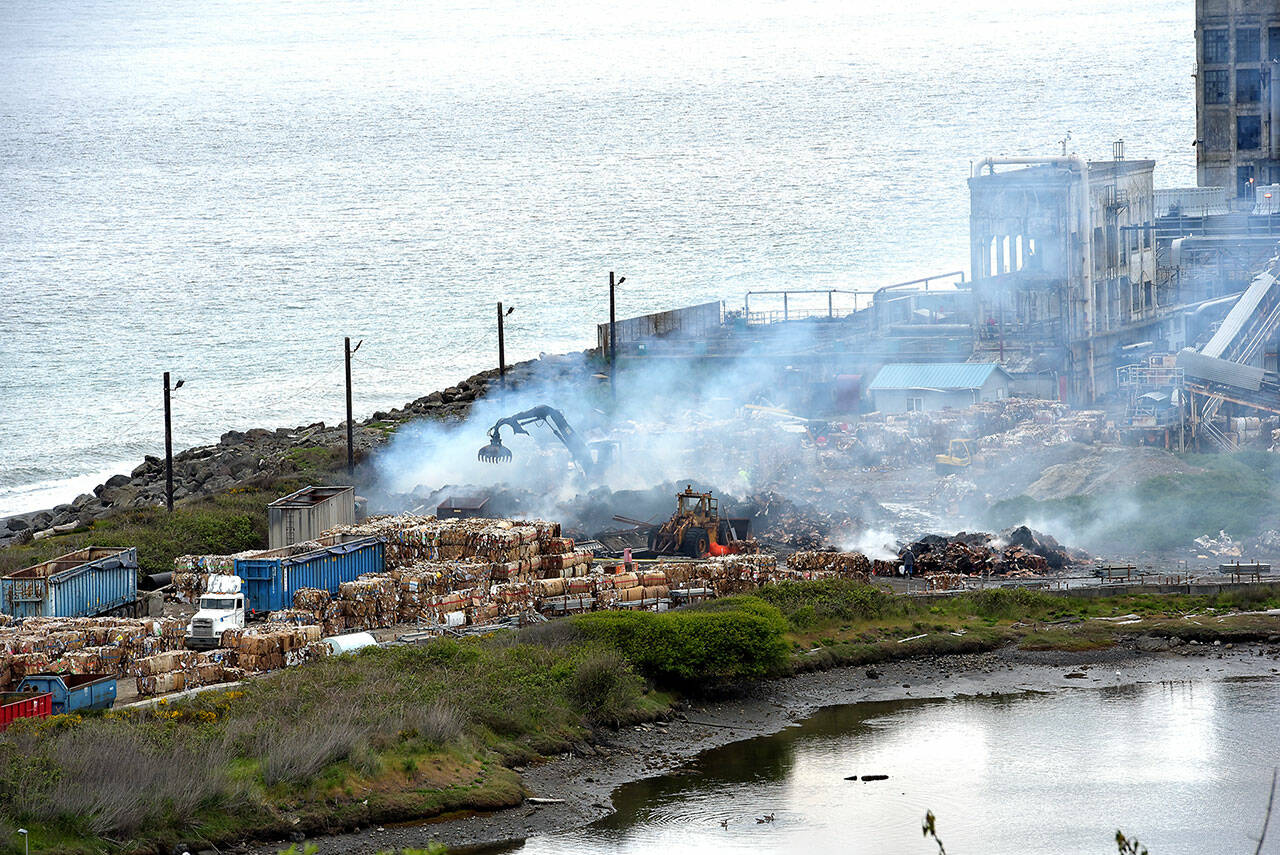 Smoke rises on Tuesday morning from the site of a baled cardboard fire that broke out late Monday night at the McKinley Paper Company on Marine Drive in Port Angeles. (Keith Thorpe/Peninsula Daily News)