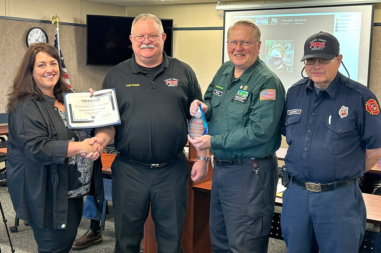 The Sequim area’s Community Emergency Response Team (CERT) program received the volunteer service award for its efforts last year. Presenting the award on April 16 was Diane Klontz, deputy director for Division and Program Alignment with the state Department of Commerce, to, second from left, Clallam County Fire District 3 Fire Chief Justin Grider, Charles Meyer, a CERT division chief, who nominated the program for the award, and CERT Senior Program Manager Blaine Zechenelly. (Matthew Nash /Olympic Peninsula News Group)