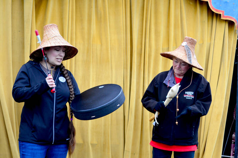 Jamestown S’Klallam Tribal Council vice chair Loni Greninger, left, and tribal elder Celeste Dybeck sing the S’Klallam paddle song, a call for people to pull together. Despite a chilly rain, scores of people attended Sunday’s 120th anniversary celebration of the golf course, an event that included the unveiling of a banner with its new name: the Camas Prairie Park and Camas Prairie Golf Course. The park is designed to serve a more diverse group of users than in the past, said Bob Wheeler, Friends of the Port Townsend Golf Park president. He added that in addition to stick golf, disc golf, foot golf, a playground, trails and native planting areas are part of the plans. (Diane Urbani de la Paz/for Peninsula Daily News)