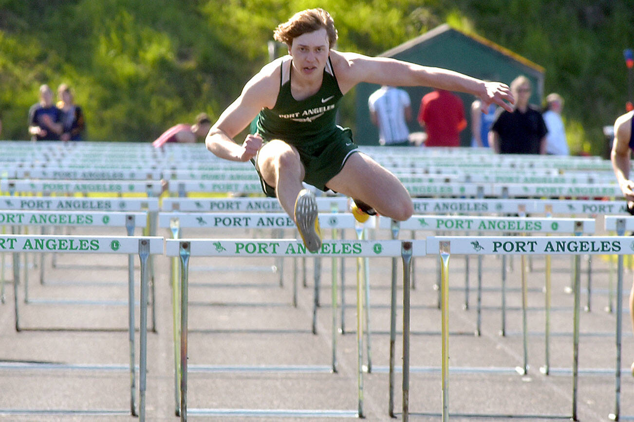 KEITH THORPE/PENINSULA DAILY NEWS
Parker Nickerson of Port Angeles leads the way to win the boys 100 hurdles on April 19 on the track at Port Angeles High School.