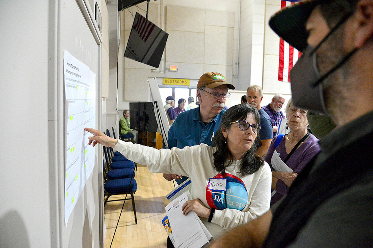 Terrie Comstock of Port Townsend asks questions about a display at the city’s kickoff meeting for its 2025 Comprehensive Plan update at the Marvin G. Shields Memorial Post 26 American Legion Hall on Thursday. The meeting was the first in a series for the update, due at the end of 2025 and required by state law. (Peter Segall/Peninsula Daily News)