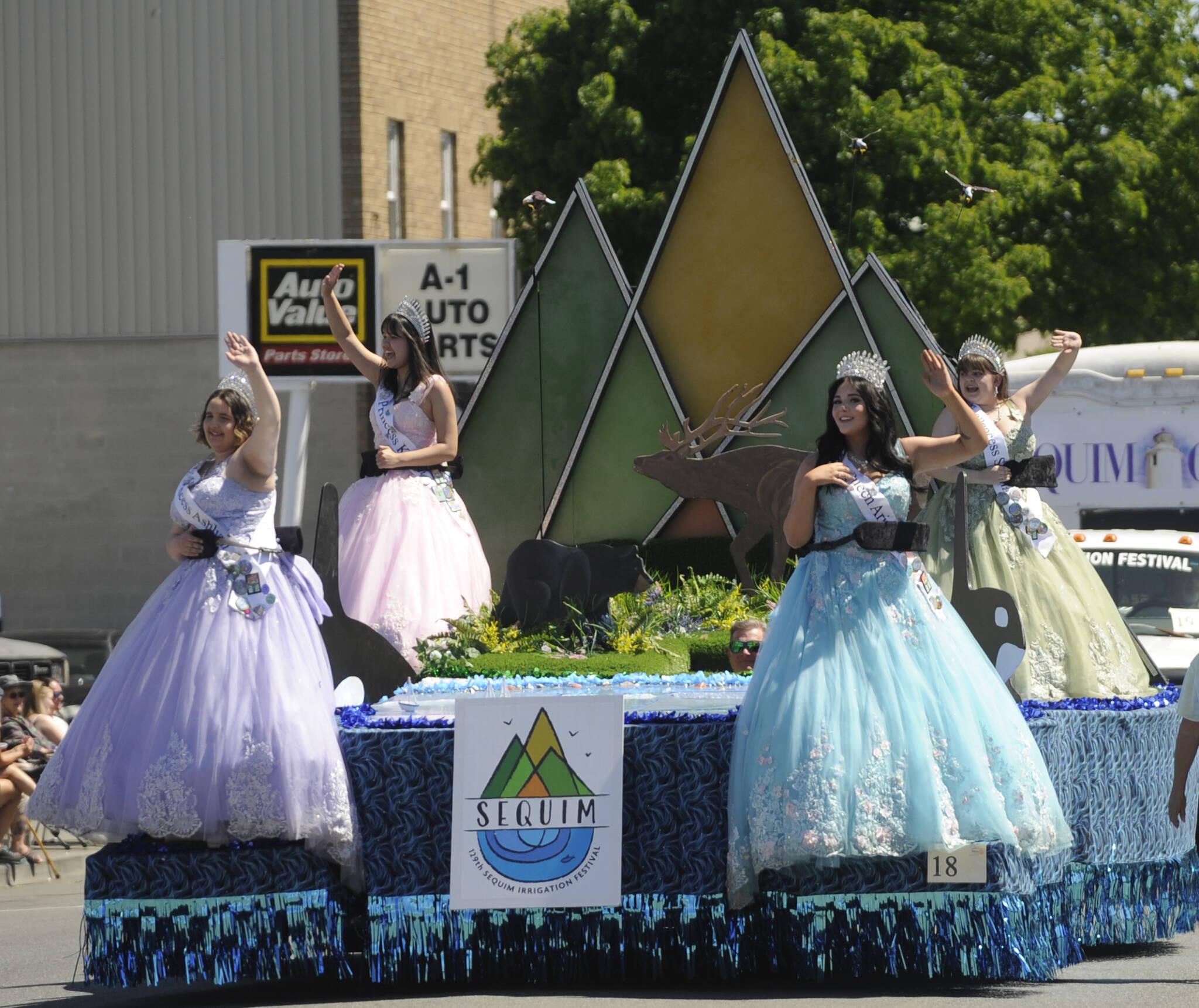 Sequim Irrigation Festival Royalty, from left, princesses Ashlynn Northaven and Kailah Blake, queen Ariya Goettling and princess Sophia Treece, wave to the Grand Parade crowd on Saturday. (Michael Dashiell/Olympic Peninsula News Group)