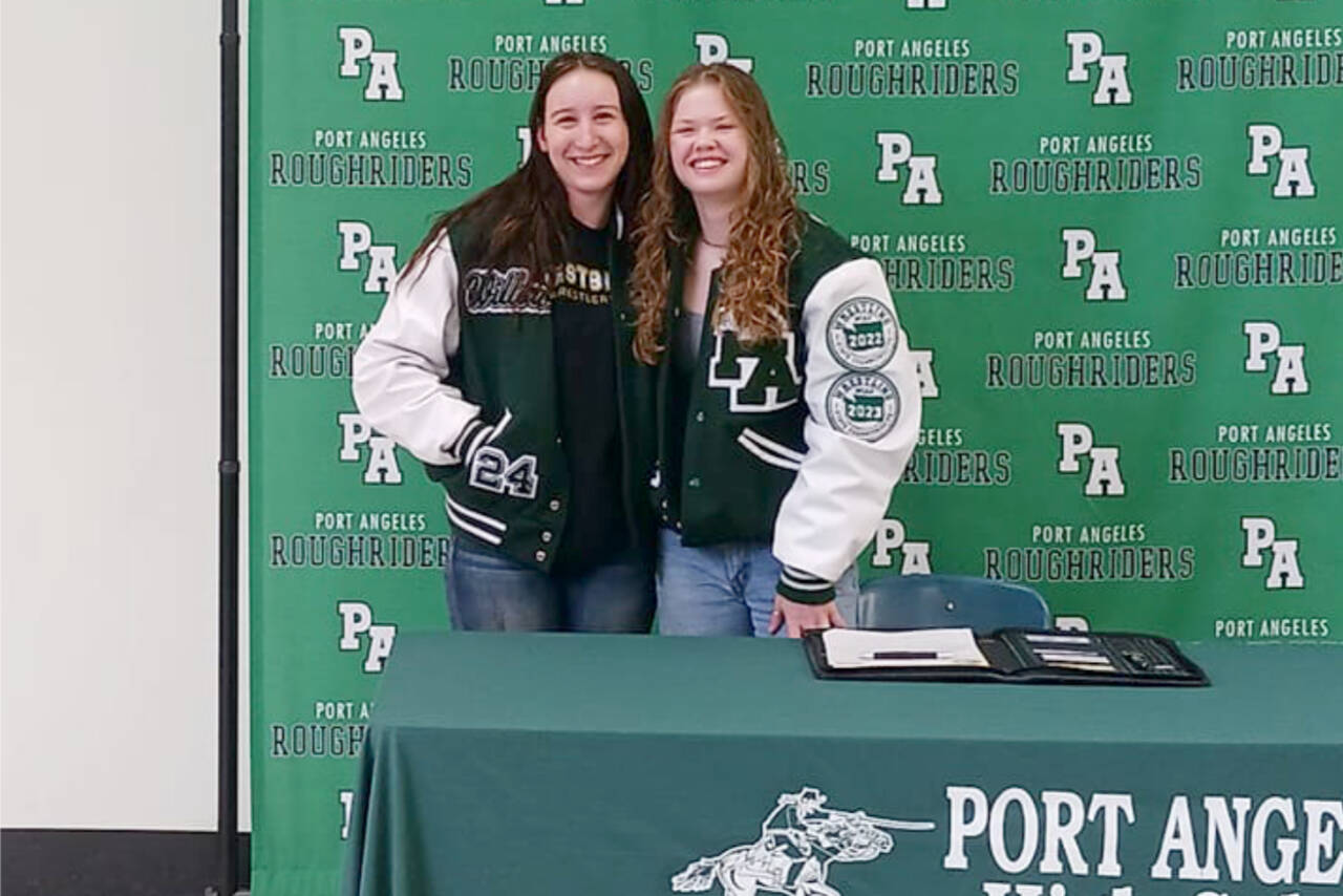 Port Angeles' Willow Harvey, left, and Faye Dachs, co-captains of the Roughriders' wrestling team are both going on to wrestle in college. Dachs just signed a letter of intent to compete for The Evergreen State College. (Pierre LaBossiere/Peninsula Daily News)