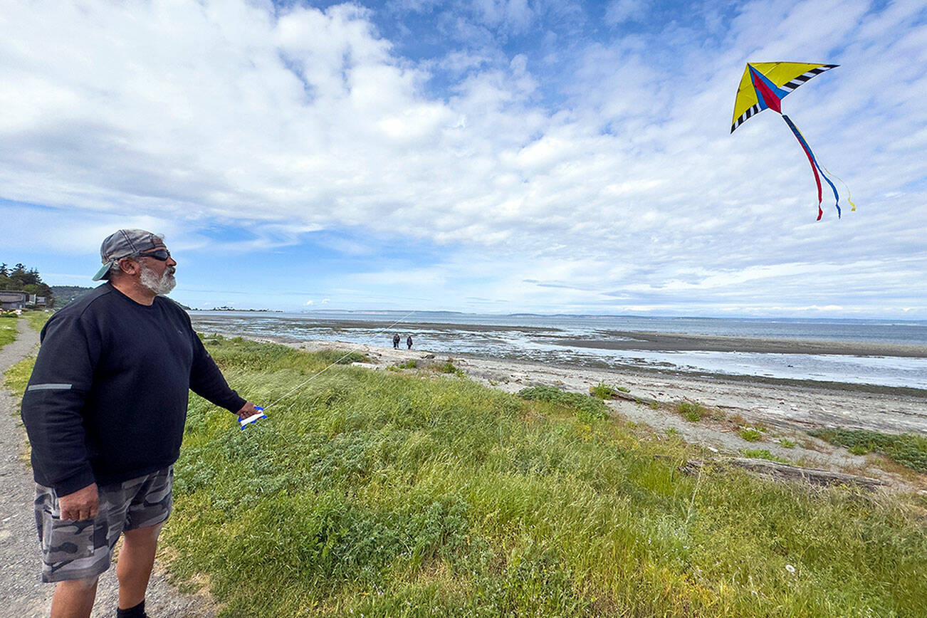 Michael Anderson of Gibsons, British Columbia tries his hand at flying a kite in the gusty winds of Point Hudson on Monday afternoon. Anderson was on the last leg of an RV vacation around the Olympic Peninsula with his wife and dog and planned on spending the next two nights at the Point Hudson Marina RV Park before they head home. (Steve Mullensky/for Peninsula Daily News)