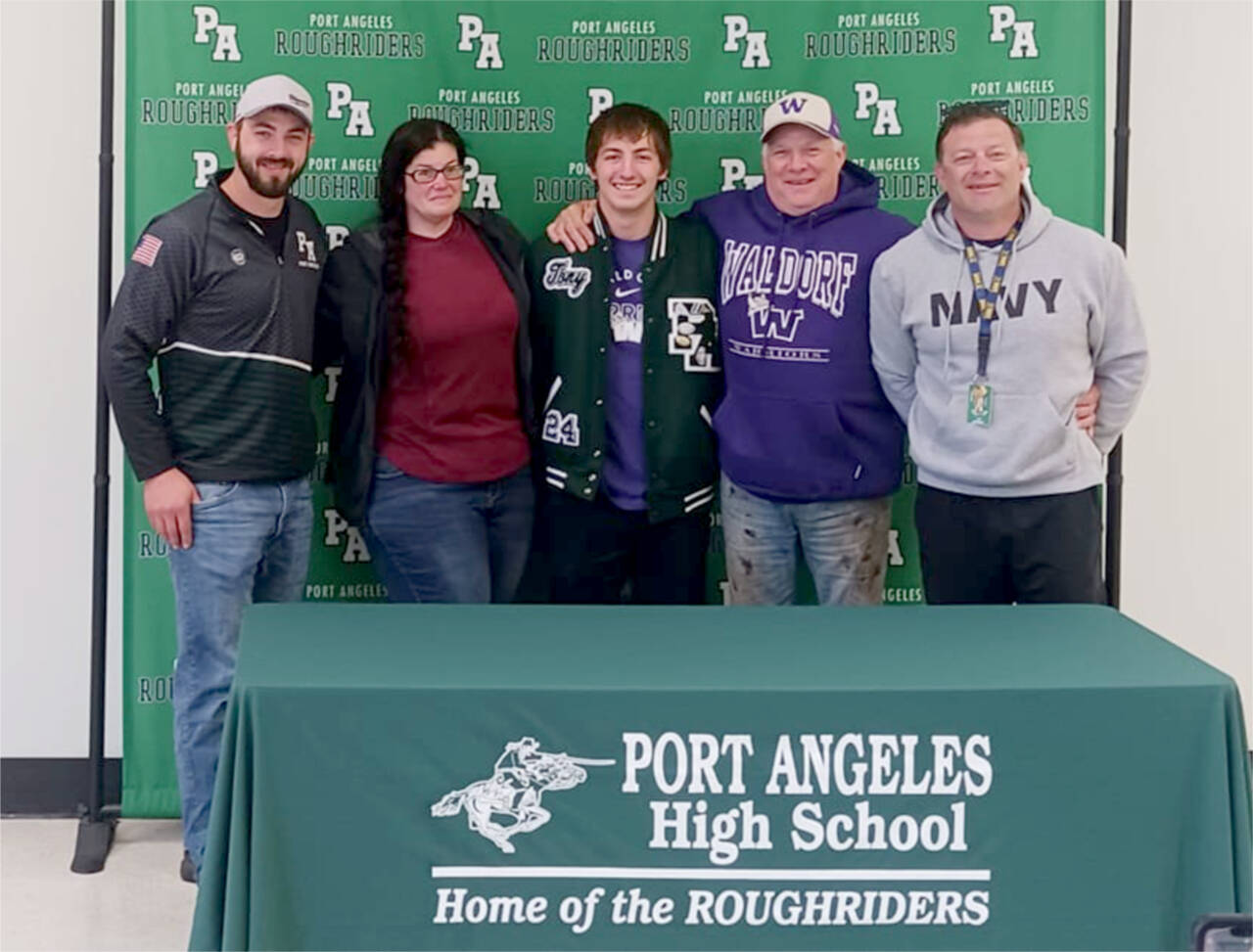 Port Angeles' Tony McMahan surrounded by coaches and family as he signed to wrestle for Waldorf University in northern Iowa. From left, are, head coach Brian Cristion, mother Sarah McMahan, Tony McMahan, father Mike McMahan and assistant coach Rob Smith. (Pierre LaBossiere/Peninsula Daily News)