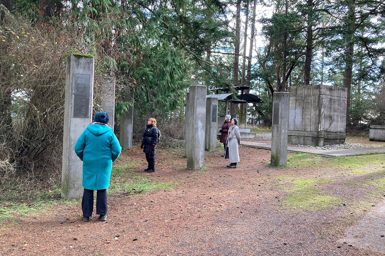 Forest bathing guide Ellen Falconer's picture of visitors to the Memory's Vault art installation at Fort Worden is among the photos in a new book. (Ellen Falconer)