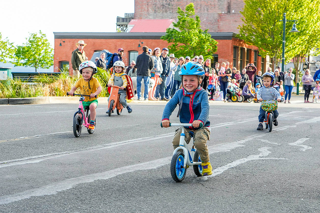Bear Chashin, 4, wins his age 3-4 trike race during the Rhody Festival Kids Trike Races on Water Street in Port Townsend on Wednesday. The festival continues with a kiddie parade, hair and beard contest and bed races today, plus the grand parade at 1 p.m. Saturday and the Rhody Run at 9 a.m. Sunday. For a complete list of events, go to https://rhodyfestival.org. (Steve Mullensky/for Peninsula Daily News)