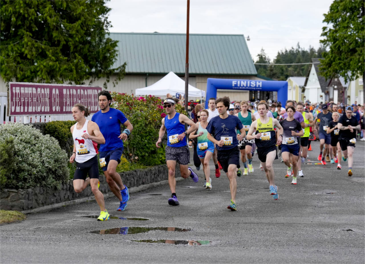 Steven Mullensky/for Peninsula Daily News
Port Townsend's Seamus Fraser, in white tank top, leads the pack at the beginning of the 44th annual Rhody Run held Sunday in Port Townsend. Fraser went on to win the 10K.