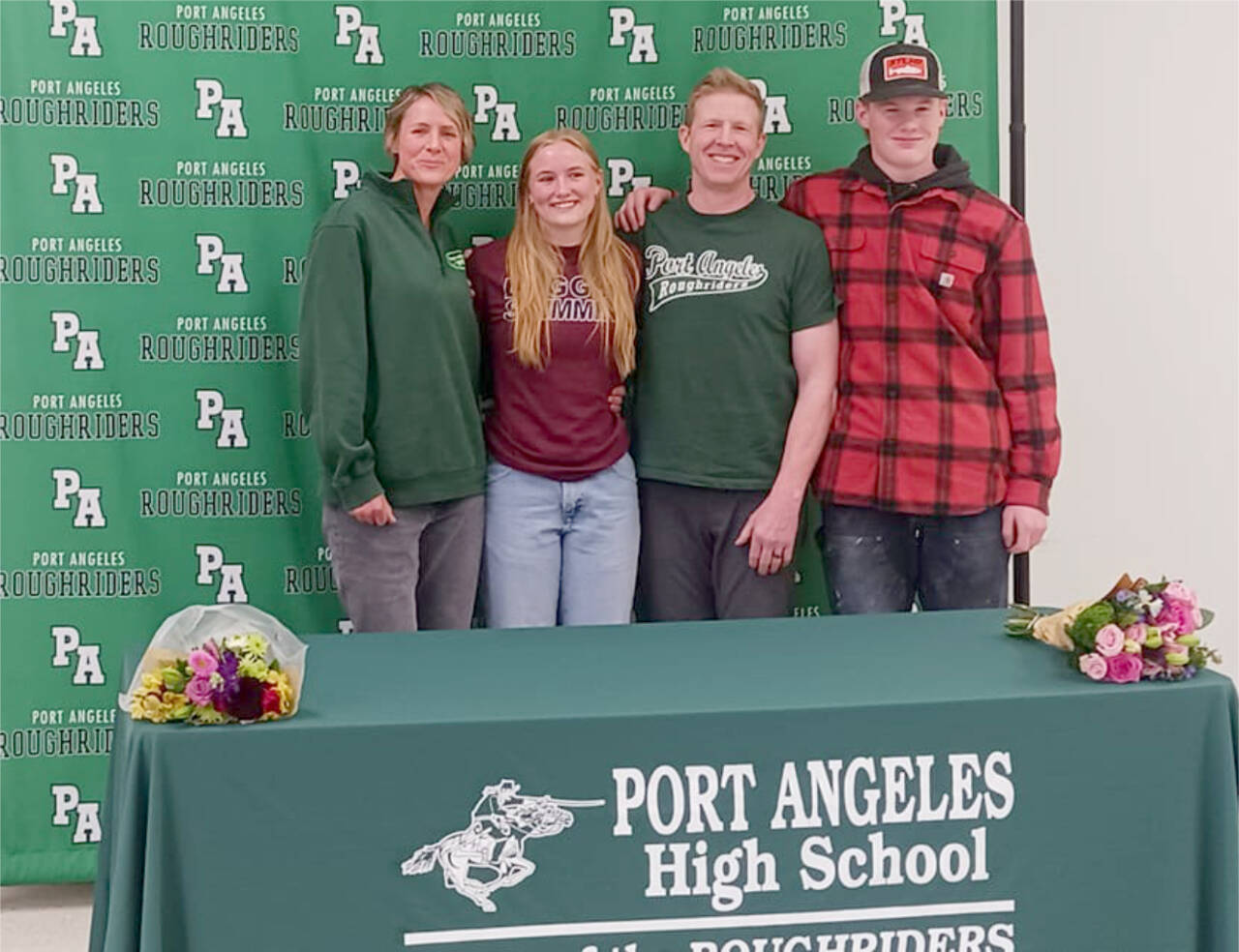 Port Angeles' Harper McGuire, a district champion in the 200 freestyle and 500 freestyle, signed Wednesday to swim for the University of Puget Sound. From left are mother Karry McGuire, Harper McGuire, father Michael McGuire and brother Ronan McGuire. (Pierre LaBossiere/Peninsula Daily News)