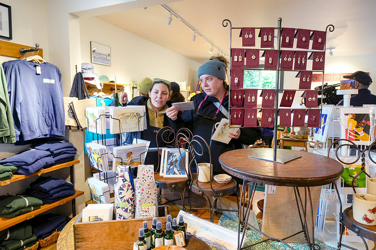 Customers at the Nordland General Store on Marrowstone Island look over cards and other items during a weekend of activities to celebrate the re-opening of the store after it had been closed for six years due to a fire. (Steve Mullensky/for Peninsula Daily News)