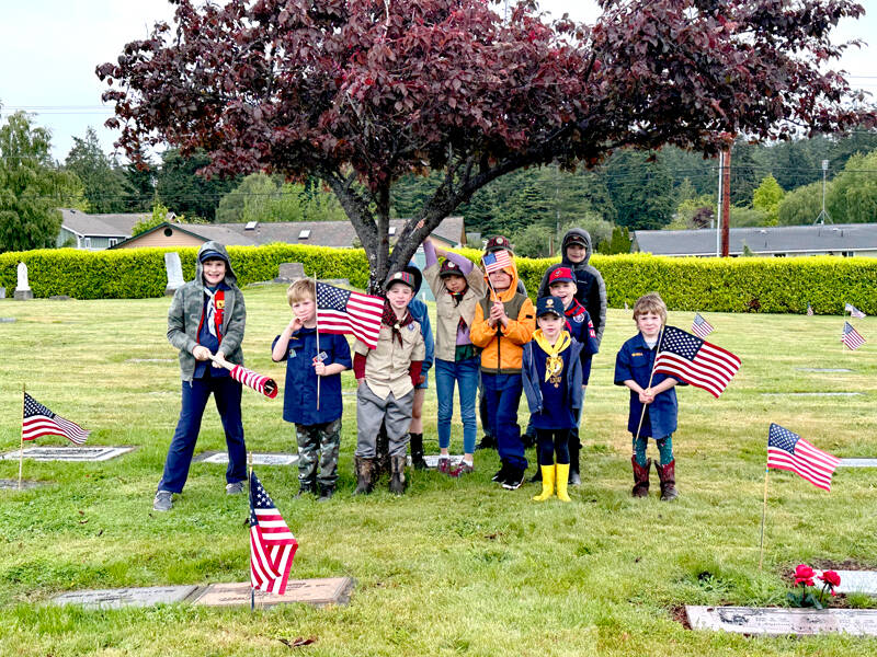 Cub Scout Pack 4479 laid about 200 flags on graves of veterans at the Catholic Cemetery and the front portion of Laurel Grove Cemetery in Port Townsend to honor veterans who have died. Jim Little from Troop 1479 instructed the Cub Scouts prior to dispersing them to post the colors at graves that were either marked with a star by the VFW or an inscription that indicates past military service. (Lolo Sherwood)