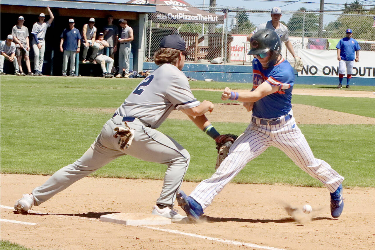 Leftie Yahir Ramirez, pinch-running for Travis Helm, tries to get back to first base on a pickoff move by the Bellingham Bells. The ball sailed into foul territory which resulted in a two-base throwing error. Ramirez ended up scoring from third base on a fly out. (Dave Logan/for Peninsula Daily News)