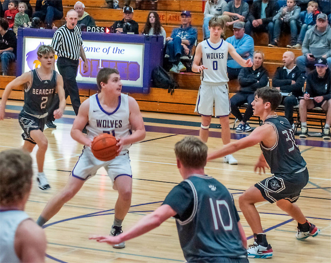 Sequims Braydan White (21) drives the lane as Ethan Melnick (0) is also in on the play Saturday in Sequim against W.F. West. The Wolves won 59-42. (Emily Matthiessen/Olympic Peninsula News Group)