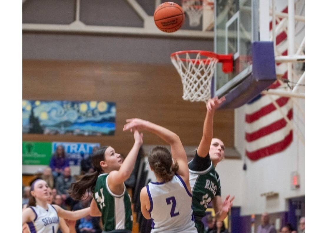 Port Angeles' Teanna Clark (10) defends a shot by Sequim's Manuela Valle Jover (2) in a game Friday in Sequim. Also in on the play are Sequim's taylor Heyting (1) and Port Angeles' Lexie Smith (34). Emily Mathiessen/Olympic Peninsula News Group