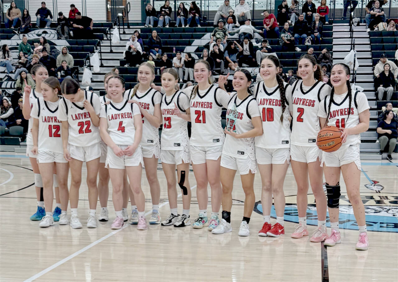 The Neah Bay Red Devils celebrate their Tri-District tournament championship Saturday night in Auburn. Neah Bay goes to state looking to win its third straight state championship. From left, are, Cerise Moss, Kandi McGimpsey (12), Destiny Lawrence (22), Brianna McGimpsey (4), Trinity Johnson, Danica Halttunen (13), Wiinuk Martin (21), Qwaapeys Greene (15), Lillie Yallup (10), Angel Halttunen (2) and Caylee Moss (11). Obscured is Tisalee Ramos. (Neah Bay Red Devils)