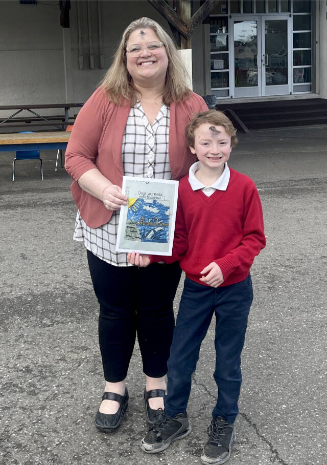 Dennis Tisdale of Queen of Angels school and his winning medal design for the North Olympic Discovery Marathon kids marathon. With him is Queen of Angeles principal Ceci Kimball. (Port Angeles Marathon Association)