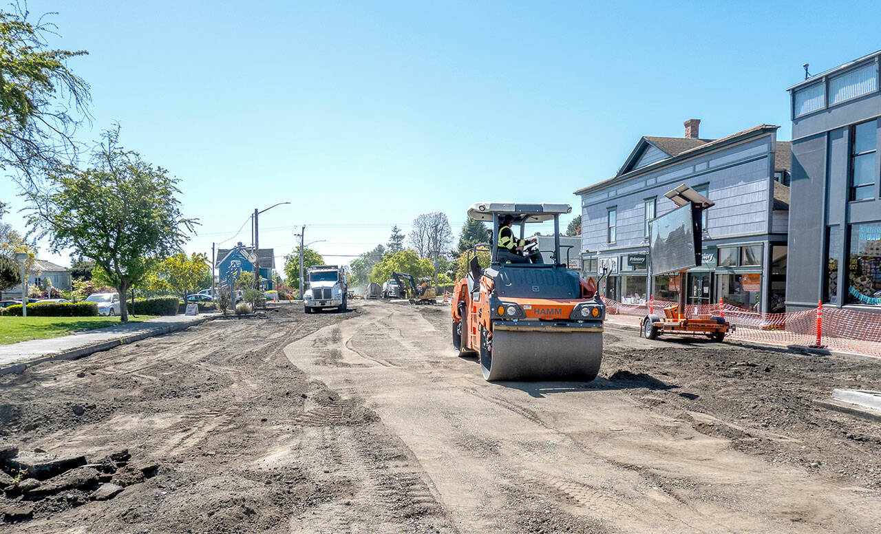 A road roller from Northern Asphalt compacts the dirt on Tyler Street in Uptown Port Townsend on Monday. The asphalt work may be finished by Wednesday to allow for striping so the street will be open in time for Saturday’s Farmers Market. (Steve Mullensky/for Peninsula Daily News)