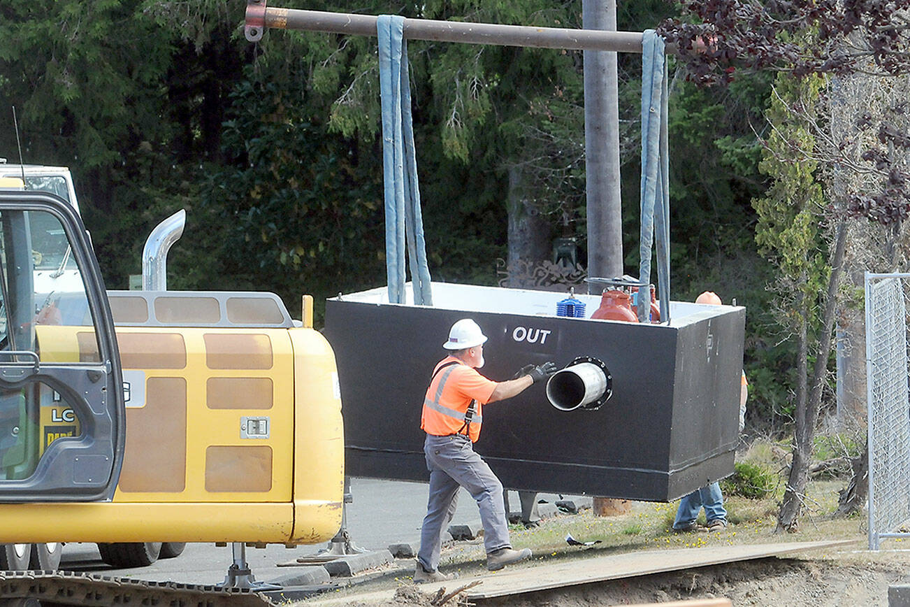 KEITH THORPE/PENINSULA DAILY NEWS
Workers maneuver a newly-delivered vault containing a water valve at the site of a valve replacement project on Thursday at the Jones Street Reservoir in Port Angeles.