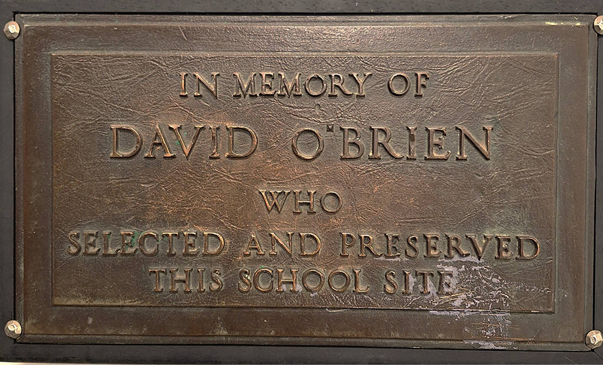 Brass plaque honoring David O’Brien’s work to set aside the Lincoln School site.