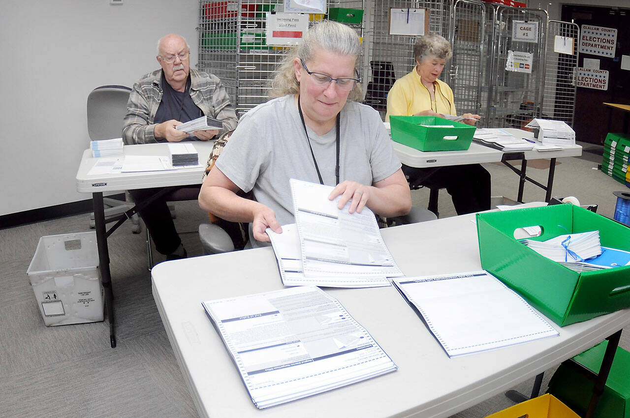 Clallam County election workers Shellie Andrews of Port Angeles, front, Ray Farrell of Forks, left, and Kathy Schreiner of Sequim organize ballots on Tuesday at the Clallam County Courthouse. Primary election results from Tuesday night are at www.peninsuladailynews.com, and coverage of the election will be in Thursdays print edition. (Keith Thorpe/Peninsula Daily News)