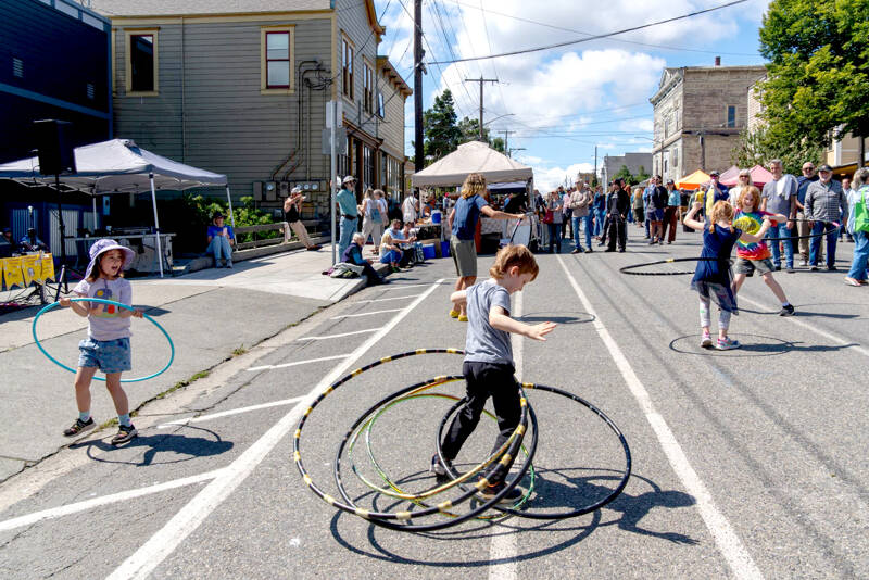 Quinn Early, 6, of Port Townsend, spins five hula hoops at once during the 33rd Uptown Port Townsend Street Fair on Saturday. (Steve Mullensky/for Peninsula Daily News)