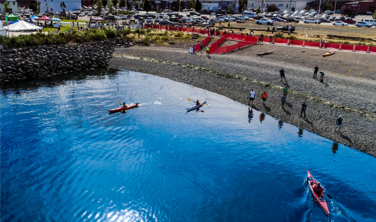 Competitors in the Big Hurt transfer to kayaks at Port Angeles Pebble Beach. (Matt Sagen/Cascadia Films)
