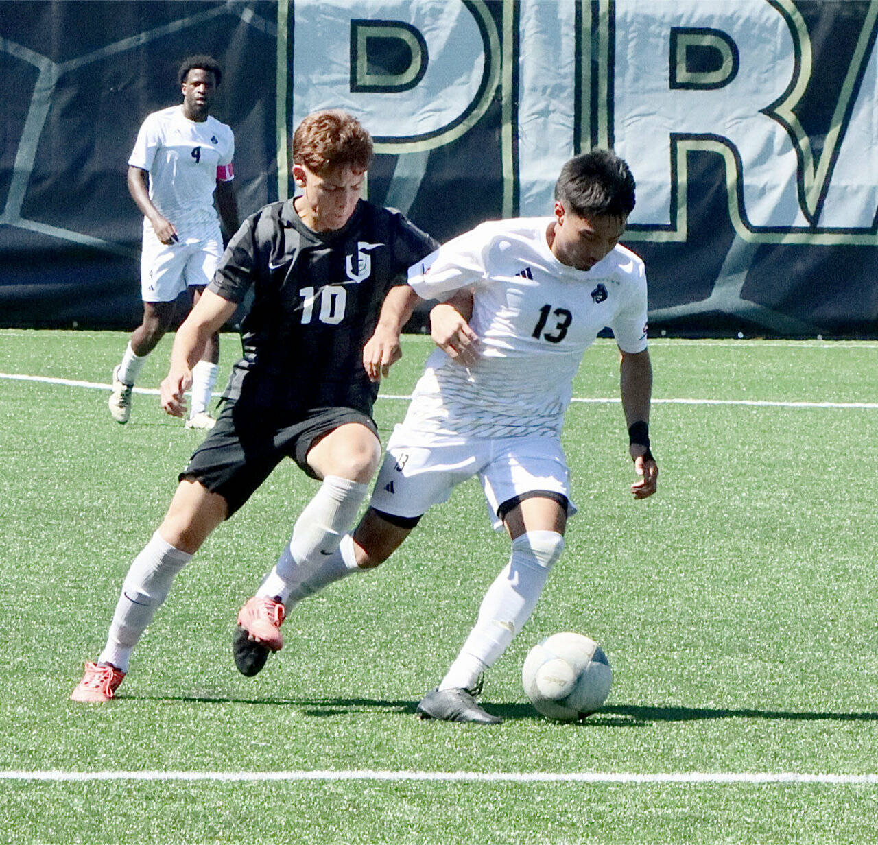 Peninsula Colleges Ezrah Ochoa battles for a ball against a defender from Wenatchee Valley on Thursday. In the background is Jeremie Kuelo. Ochoa scored 14 goals for the Pirates last season and is expected to be one of the teams top offensive weapons this season. (Dave Logan/for Peninsula Daily News)